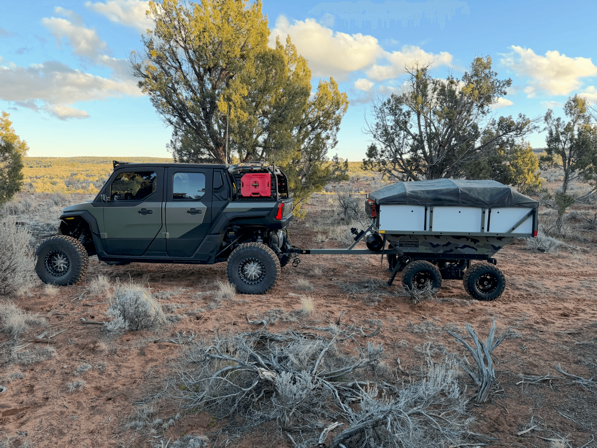 UTV towing a HighCountry Unlimited camp trailer through desert terrain